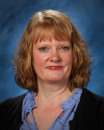 Teacher/librarian with blue shirt and black sweater 